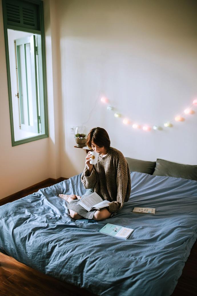 Woman sitting on bed and reading a book. Woman sitting on bed and reading a book.